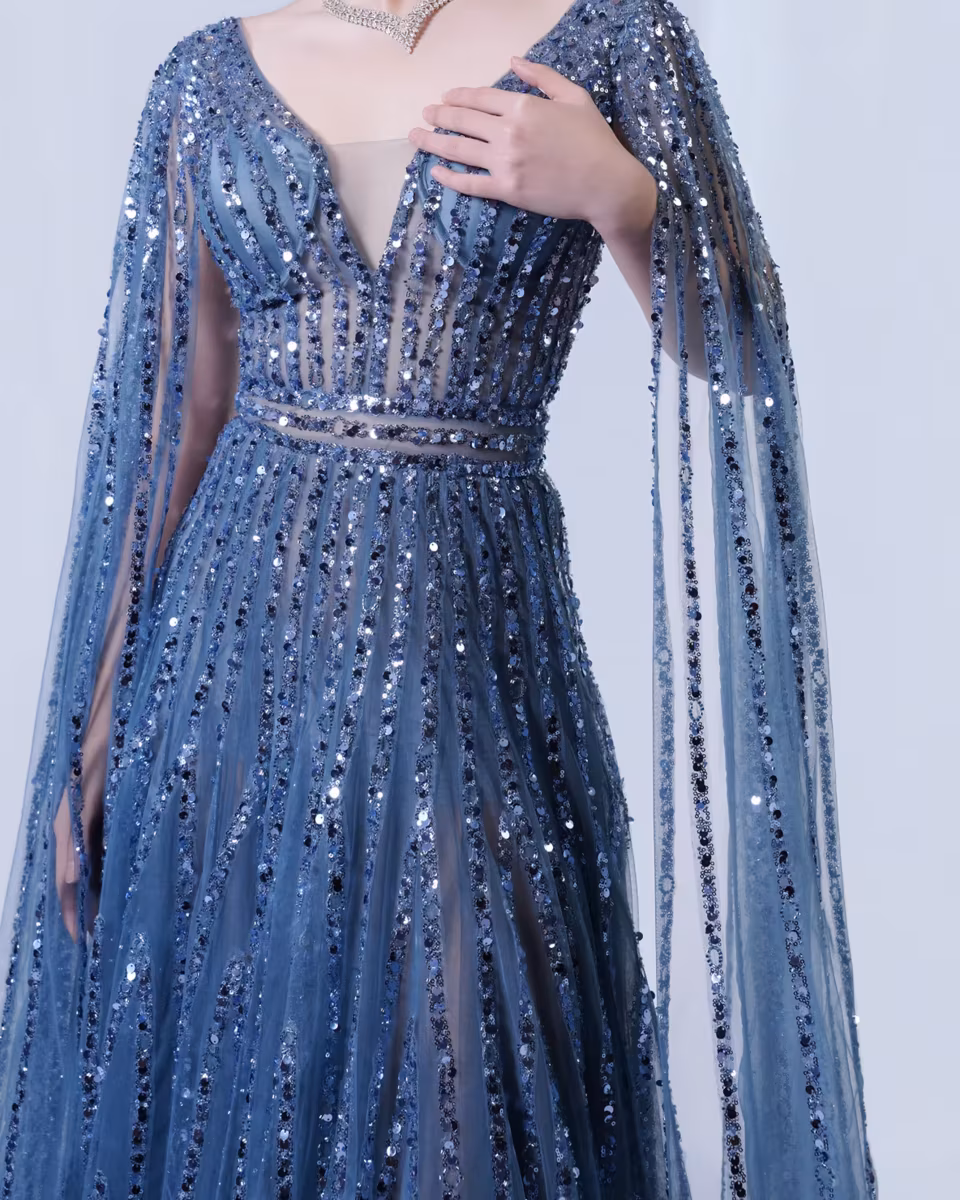 Sheer sequin cape overlay detail